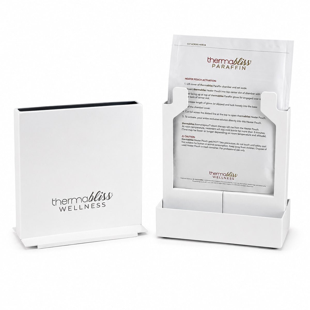 thermabliss Metal Paraffin Heating Chamber; thermabliss metal heating chamber for paraffin gloves and booties; compact vertical thermabliss paraffin heating chamber; metal thermabliss heating chamber in a wellness treatment setting; thermabliss paraffin chamber with compact vertical design; commercial-grade metal paraffin heating chamber; thermabliss heating system using mineral heater pouch and tap water; thermabliss Metal Heating Chamber for client-exclusive paraffin treatments. 