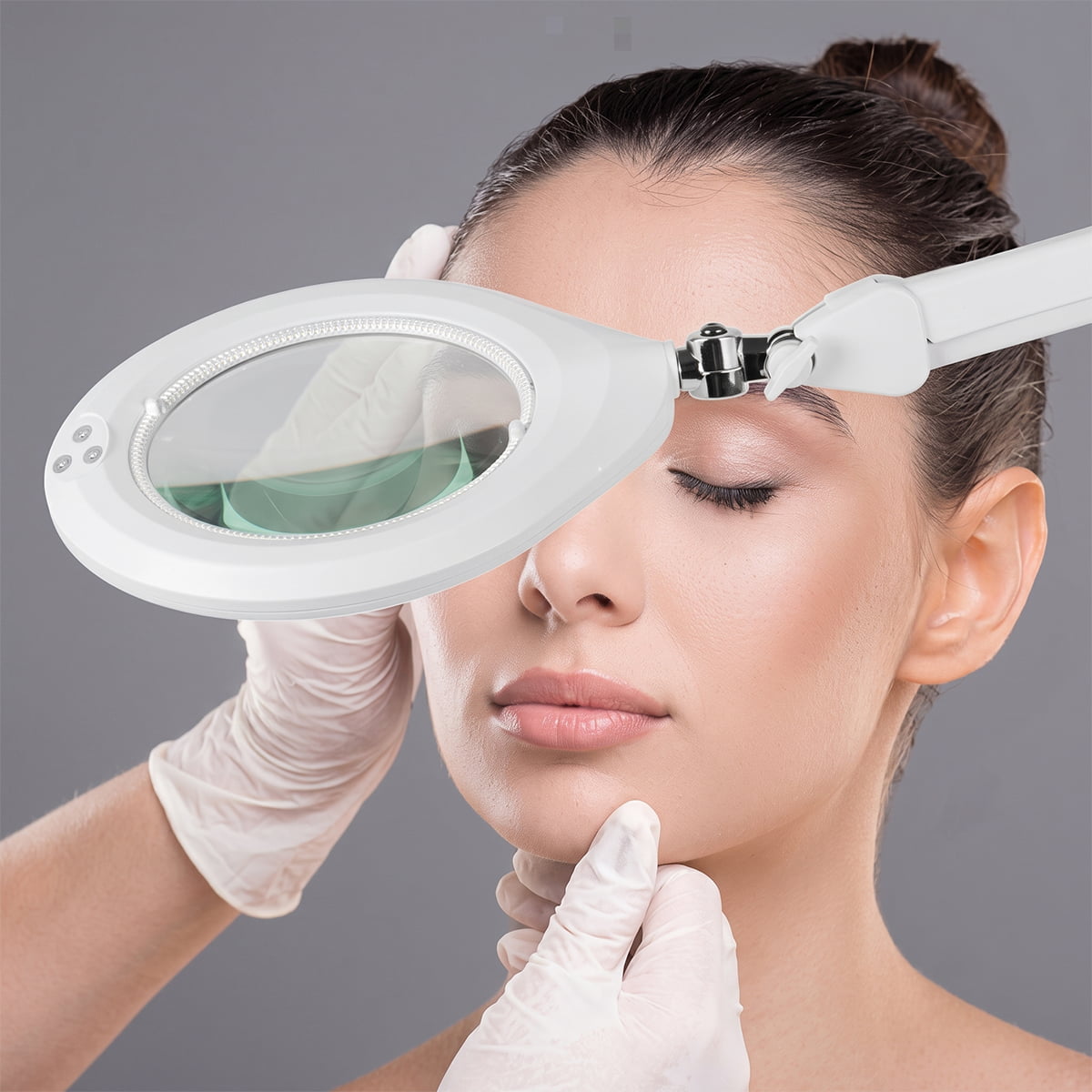 Silhouet-Tone C103 professional LED magnifying lamp; C103 magnifying lamp with articulated arm; 7-inch glass lens on Silhouet-Tone C103 lamp; LED ring surrounding the C103 magnifying lens; C103 table-clamp magnifying lamp for estheticians; Silhouet-Tone magnifying lamp positioned over a treatment table; Touch dimmer control on C103 LED magnifying lamp; Table clamp attachment for Silhouet-Tone C103 lamp.