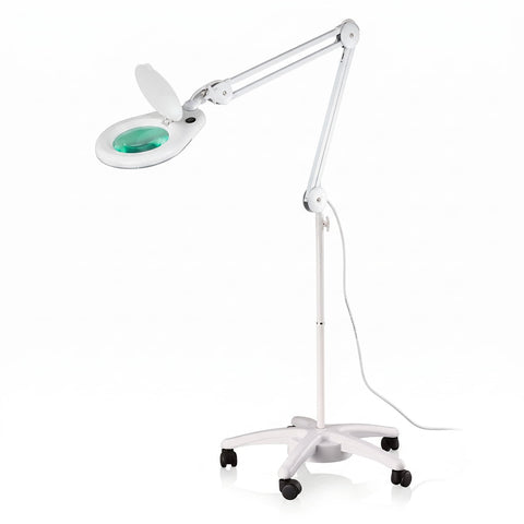 Silhouet-Tone L524 floor stand magnifier lamp; White L524 freestanding magnifier lamp; Silhouet-Tone magnifier lamp with five-foot floor base; L524 floor stand for professional treatment rooms; White floor stand magnifier lamp beside a treatment table; Five-foot base on Silhouet-Tone L524 lamp; L524 magnifier lamp for esthetician workspaces; Disassembled L524 floor stand components before assembly